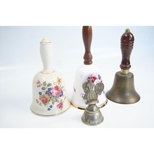 94 - A Collection of Ceramic, Brass, and Figural Hand BellsAn assortment of various hand bells of ceram... 
