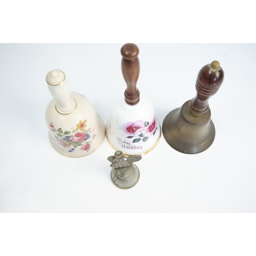 94 - A Collection of Ceramic, Brass, and Figural Hand BellsAn assortment of various hand bells of ceram... 