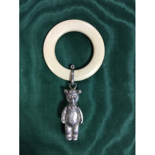 1 - A silver teddy bear shaped rattle -