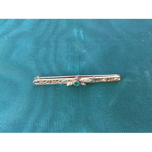 10 - An early 20th century bar brooch,
set to the centre with a gem set butterfly -