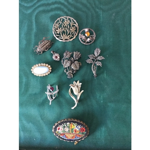 11 - A small group of brooches,
to include micromosaic brooch, silver and marcasite brooches etc -