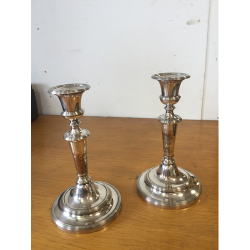 36 - A pair of silver plated candlesticks -