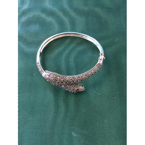 48 - A silver snake bangle,
designed as two marcasite set snake heads -