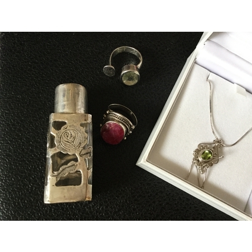 52 - A silver and peridot necklace,
together with two silver rings and a scent bottle -