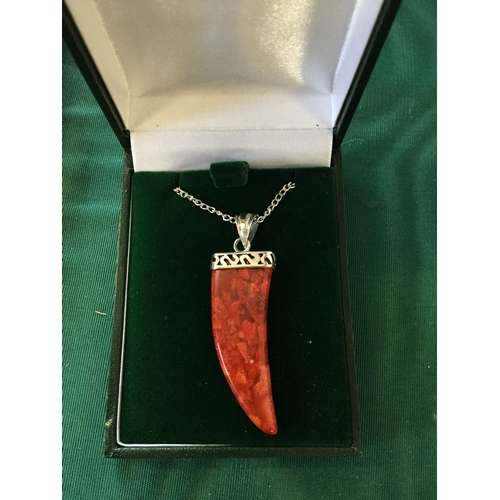 62 - A silver and apple coral pendant on chain -