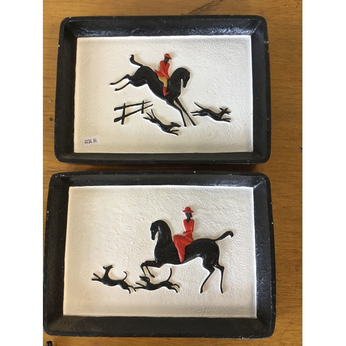 118 - A pair of moulded and painted plaques,
each depicting an equestrian scene -