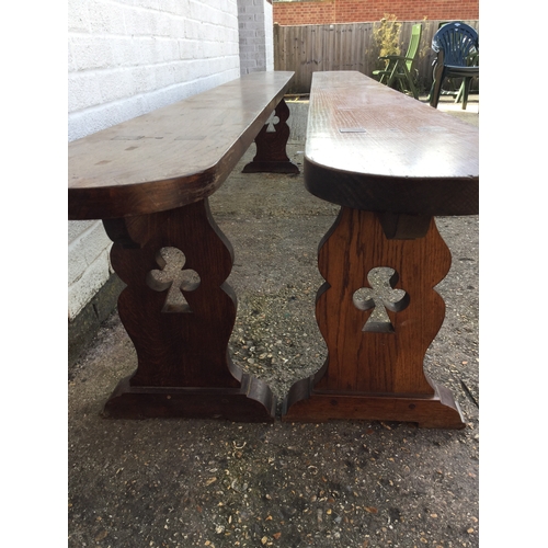 330 - A pair of long oak benches,
each pierced with clover to end support -