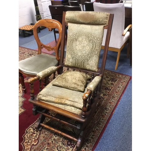 357 - An American turned walnut rocking chair,
with spring action and upholstered in pale green -