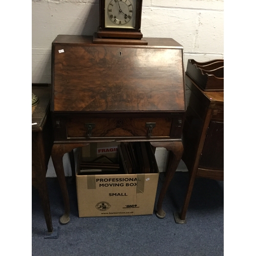389 - An early 20th century walnut finish bureau,
with fall front enclosing fitted interior, on slender ca... 