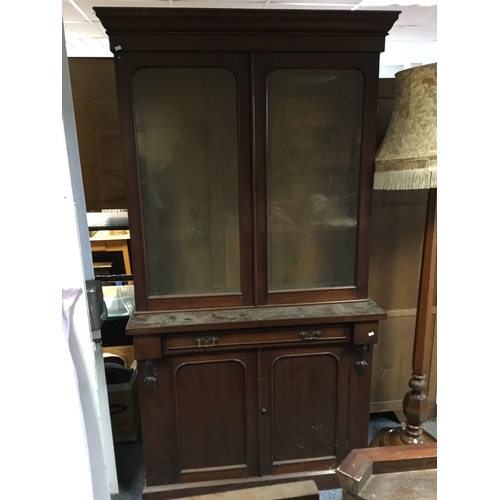390 - An Edwardian bookcase,
the glazed top enclosing shelves over one drawer and cupboard doors -