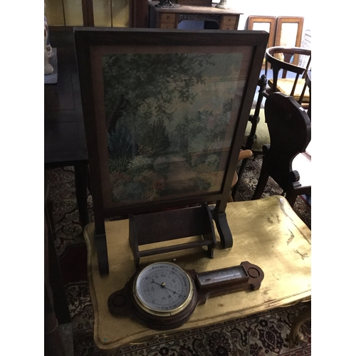 395 - An early 20th century oak framed firescreen,
together with a bookrest and a barometer (3) -
