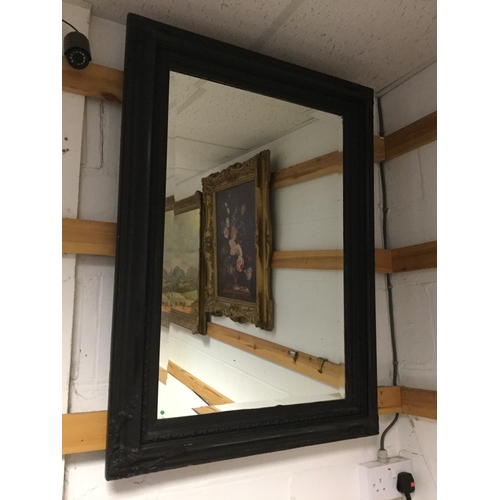 396 - A rectangular wall mirror,
painted black -