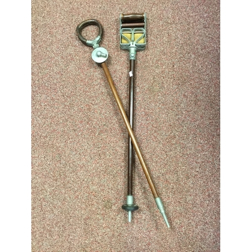 406 - A 'Preston' shooting stick,
together with another similar -