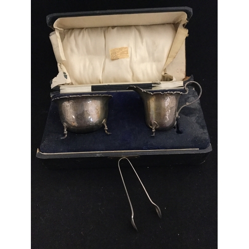 44 - A cased silver cream jug, sugar basin and tongs, 
Birmingham -