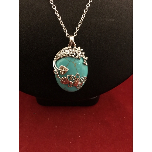 7 - A turquoise coloured silver mounted pendant on chain -
