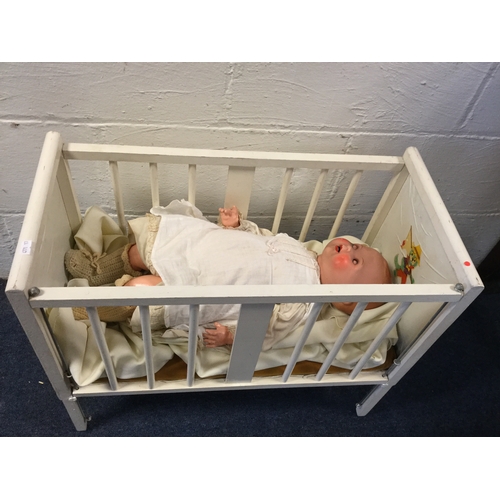 195 - A vintage dolls crib, 
together with a jointed doll, marked A S, with open/close eyes and painted op... 