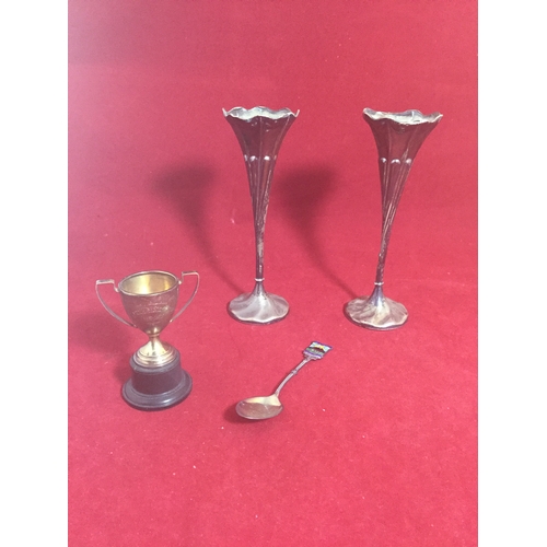 19 - A pair of filled silver bud vases, 
together with a small silver trophy cup and a silver and enamel ... 
