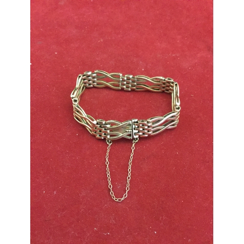 23 - A 9ct gold gate style bracelet, 
with safety chain -
