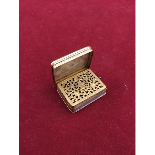 54 - A Georgian yellow metal vinaigrette, 
with lift top revealing a pierced grill, later suspension loop... 