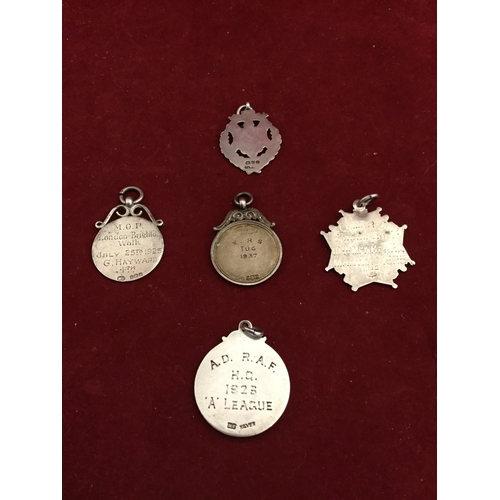65 - Five silver medals, 
various dates and makers, including military interest -