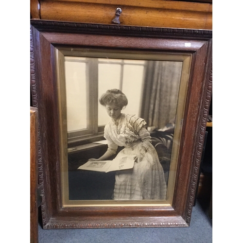 180 - A large oak frame containing a photographic portrait of an Edwardian lady -