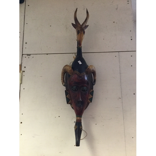 208 - Two vintage wall masks,
together with a tribal carving and another mask -