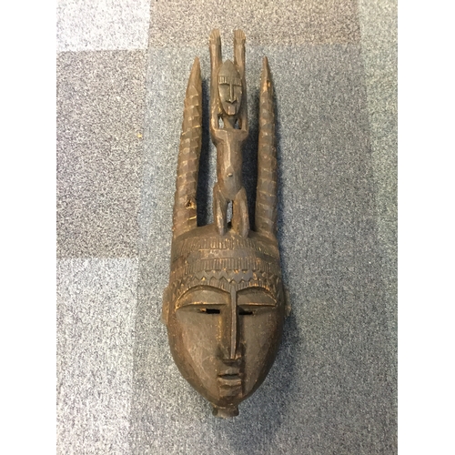 209 - A large heavily carved mask -