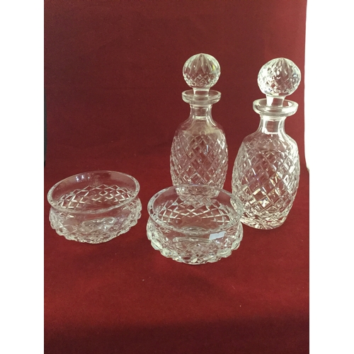 95 - Waterford: A pair of cut glass decanters and stoppers, together with a pair of footed bowls -