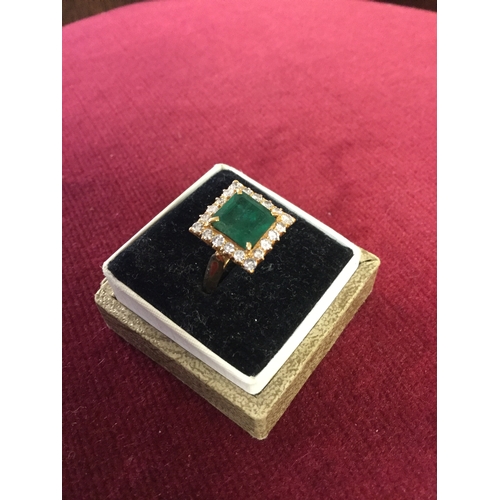 15 - An emerald and diamond cluster ring, 
with square emerald claw set in a border of diamonds, all in y... 