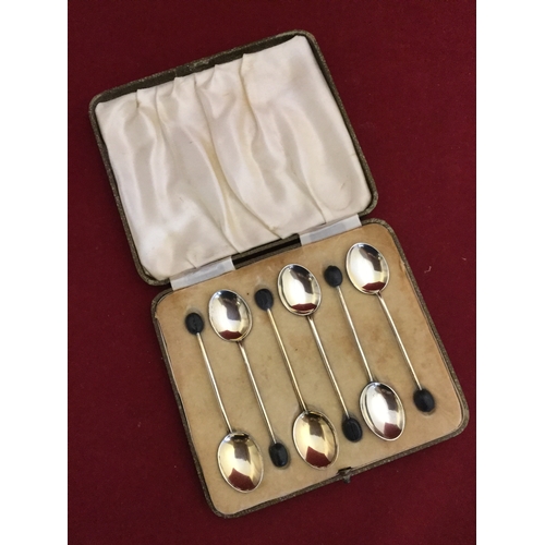 36 - A set of six silver and enamel bean end teaspoons 
(some damage) -