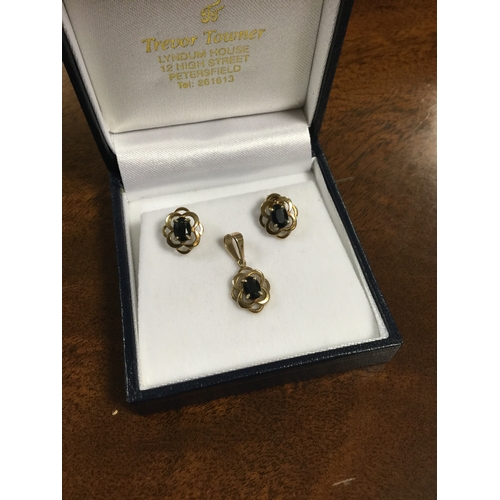 38 - A pair of sapphire earrings, 
set in openwork yellow metal mount and a matching pendant -