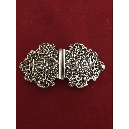 50 - A silver two piece buckle, 
with figural and leaf decoration to each side -