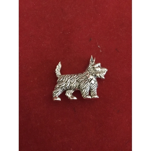 59 - A silver brooch, in the form of a Scottie dog, 
with ruby eye -