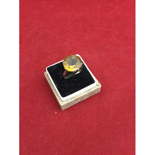 64 - A 9ct gold cocktail ring, 
set with a large golden topaz coloured stone -