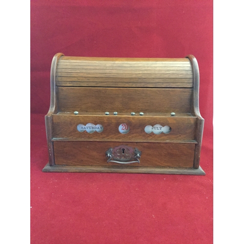 78 - An early 20th century oak stationery box/perpetual calendar, with roll top to rack, over date and dr... 