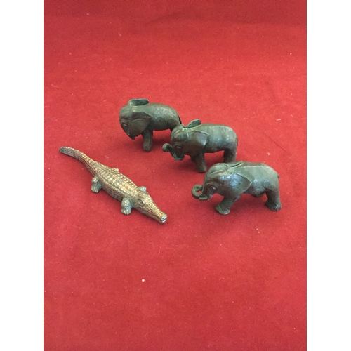 79 - A group of three bronze elephants and a similar crocodile -