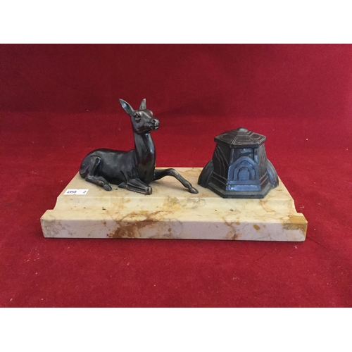 81 - An Art Deco inkwell, 
the rectangular marble base with hexagonal inkwell and beside stylised deer -