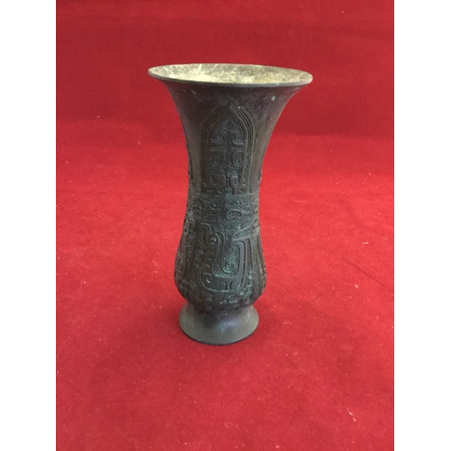 93 - A Chinese bronze vase, archaic style, 
with animal decoration below a fluted rim -