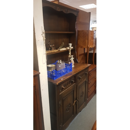 262 - An oak dresser, of small size, with shelved top over 
two drawer and cupboard doors -