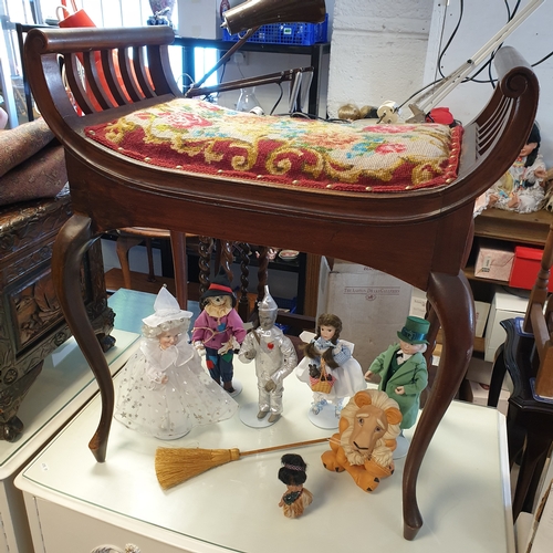 264 - An Edwardian piano stool, with pierced sides, 
tapestry seat and cabriole legs -