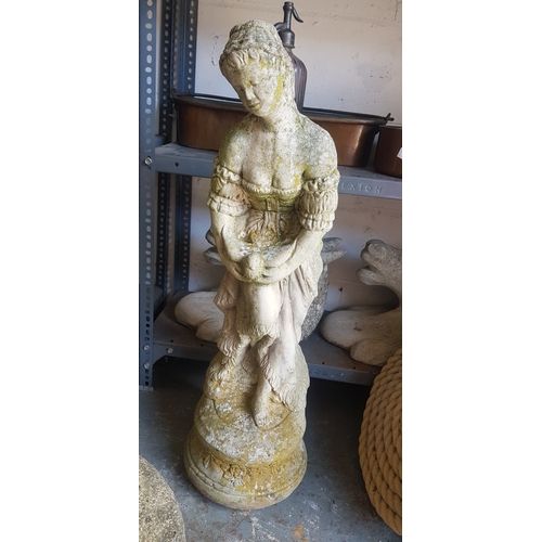 367 - A garden statue of a classical figure holding a bird -