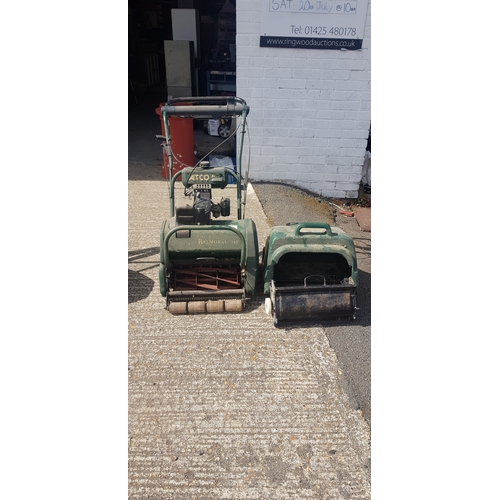 369 - An Atco petrol cylinder lawn mower, 
with attachments -