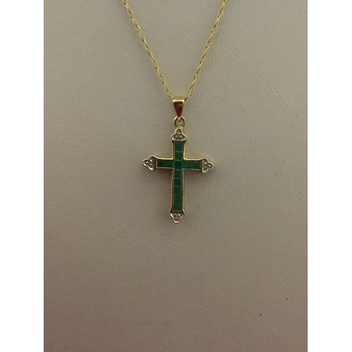 93 - A 9ct gold gem set pendant of cross design and set with calibre emeralds and diamonds, on 9ct chain ... 