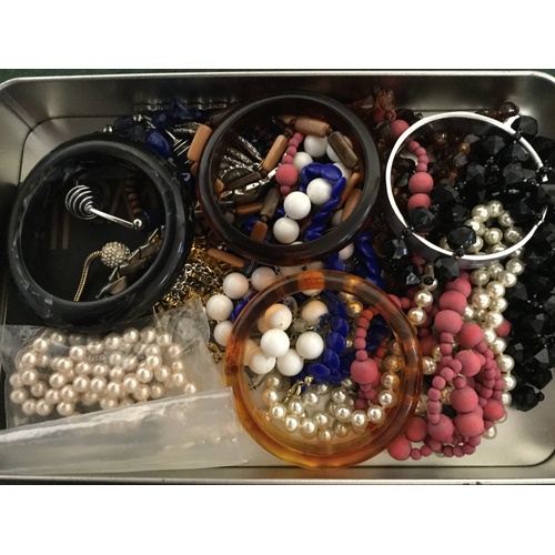 22 - A tin of costume jewellery -