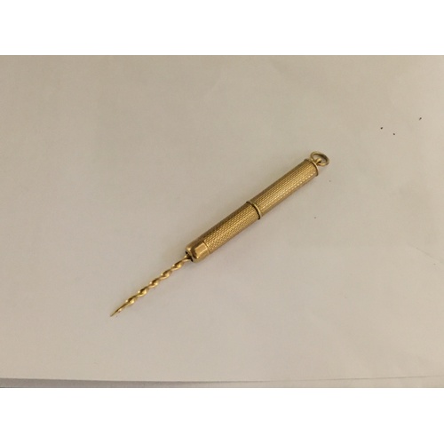 13 - A 9ct gold toothpick, with screw action, machine turned engraving and suspension loop -