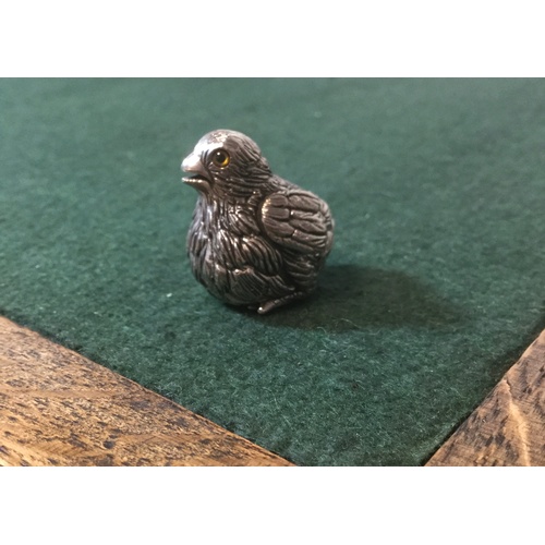 31 - A silver model of a chick -