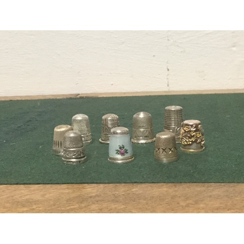 35 - A collection of thimbles, including silver and enamel example, Charles Horner and other silver examp... 