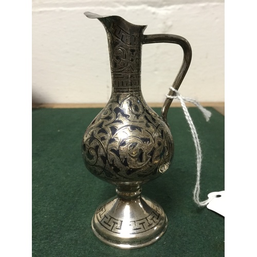 42 - A white metal and niello ware jug, apparently unmarked -