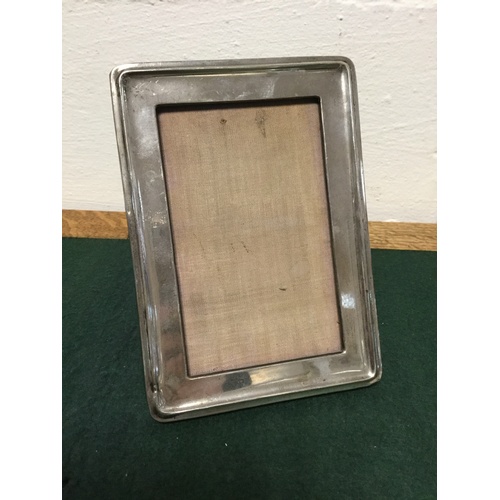 50 - A silver faced easel backed photograph frame -