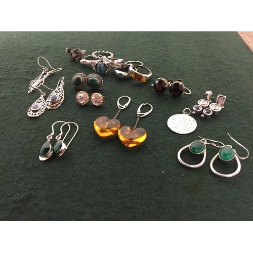 61 - A selection of mostly silver rings and silver mounted earrings, including examples set with amber, m... 